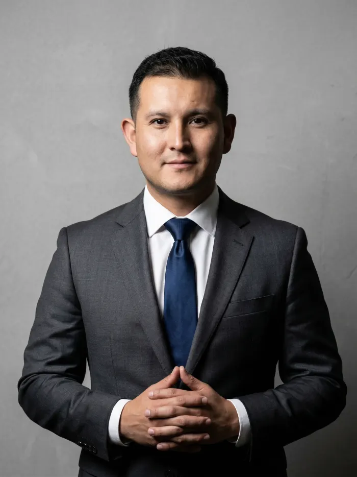 Dennis Alejo in a dark suit and blue tie